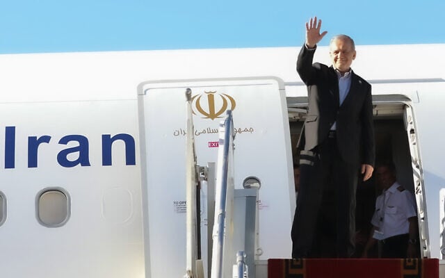 In this photo released by the Iranian Presidency Office, President Masoud Pezeshkian waves to media and officials as he boards his plane while leaving Mehrabad airport for New York to attend the UN General Assembly, in Tehran, Iran, September 22, 2026. (Iranian Presidency Office via AP)