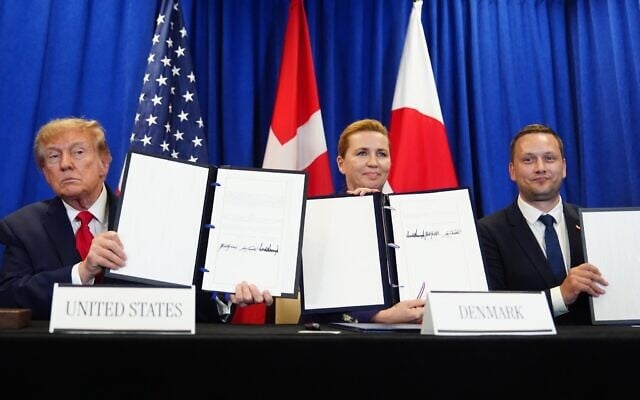 US President Donald Trump (L) signs a security agreement with Denmark’s Prime Minister Mette Frederiksen (C)and Greenland’s Prime Minister Jens-Frederik Nielsen during the United Nations General Assembly, September 22, 2026, at the UN headquarters. (Julia Demaree Nikhinson/AP)