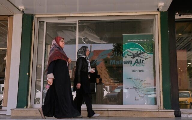 Pedestrians walk past an office of Iranian airline Mahan Air in Baghdad, Iraq, September 23, 2026. (AP/Hadi Mizban)