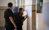 People check their names on voters lists inside a polling station during the legislative elections in Rabat, Morocco, September 23, 2026. (AP Photo/Mosa’ab Elshamy)
