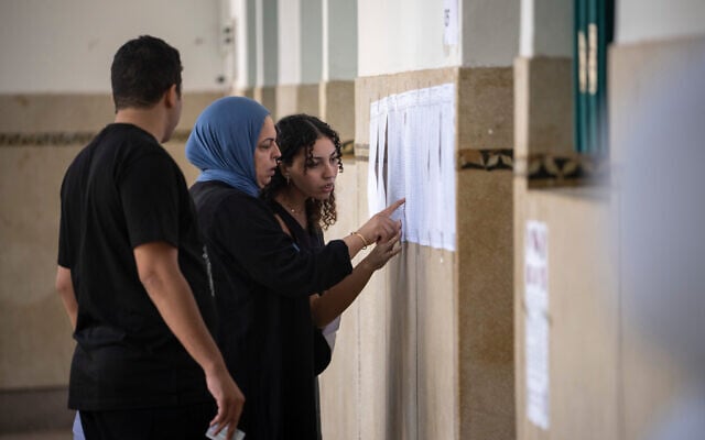 People check their names on voters lists inside a polling station during the legislative elections in Rabat, Morocco, September 23, 2026. (AP Photo/Mosa’ab Elshamy)