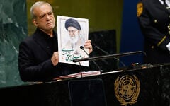 Iran’s President Masoud Pezeshkian holds an image of late Iranian supreme leader Ayatollah Ali Khamenei during the 81st session of the United Nations General Assembly at United Nations headquarters, September 23, 2026. (AP Photo/Stefan Jeremiah)