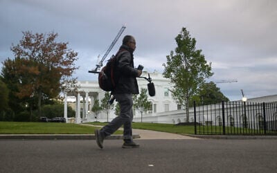 A CNN sound technician walks at the White House, September 26, 2026, in Washington. (AP Photo/Rod Lamkey, Jr.)