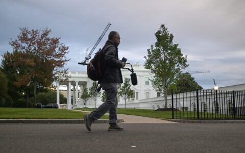 A CNN sound technician walks at the White House, September 26, 2026, in Washington. (AP Photo/Rod Lamkey, Jr.)