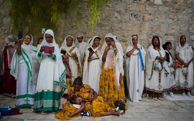 Ethiopian Orthodox Christian worshippers gather for celebrations on the eve of the Meskel holiday at the Ethiopian monks' village, Deir Al‑Sultan, located on the rooftop of the Church of the Holy Sepulcher in Jerusalem's Old City, Saturday, Sept. 26, 2026. (AP Photo/Ohad Zwigenberg)