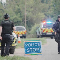 Police stand at a road block on the road to RAF Fairford after an incident, in Whelford, England, September 27, 2026 . (Ben Birchall/PA via AP)