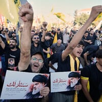 Hezbollah supporter chant slogans as they hold placards bearing the Arabic words “We will avenge you” during a ceremony marking the second anniversary of the assassination of Hezbollah leader Hassan Nasrallah, who was killed in Israeli airstrikes, at Nasrallah’s shrine in Beirut, Lebanon, September 27, 2026. (AP Photo/Bilal Hussein)