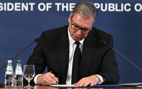 Serbian President Aleksandar Vucic signs his resignation as president in order to run for prime minister, in Belgrade, Serbia, September 27, 2026. (Serbian presidential press office via AP)