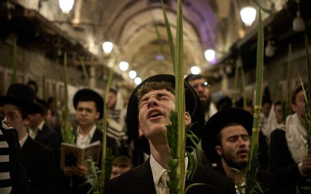 Orthodox Jewish men pray in front of the gate at Souq Al-Qattanin, or Cotton Merchants’ Market, one of the entrances to the Temple Mount/Al-Aqsa Mosque compound in the Old City of Jerusalem, September 28, 2026, during morning prayers for the Jewish holiday of Sukkot. (AP/Leo Correa)