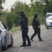 Police guard a road leading to RAF Fairford, in Fairford, England, a day after British counterterrorism police were probing “a major” incident near the base, September 28, 2026. (AP Photo/Alastair Grant)