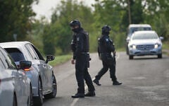 Police guard a road leading to RAF Fairford, in Fairford, England, a day after British counterterrorism police were probing “a major” incident near the base, September 28, 2026. (AP Photo/Alastair Grant)