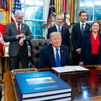 US President Donald Trump winks as the members of the media depart the Oval Office of the White House as Essar Capital Director Prashant Ruia, from left, Energy Secretary Chris Wright, Commerce Secretary Howard Lutnick, John Jovanovic, chairman of the Export-Import Bank of the United States, Iowa Attorney General Brenna Bird, Mariannette Miller-Meeks, R-Iowa., and Rep. Ashley Hinson, R-Iowa, look on, September 28, 2026, in Washington. (AP Photo/Alex Brandon)