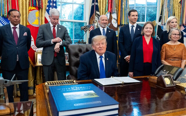 US President Donald Trump winks as the members of the media depart the Oval Office of the White House as Essar Capital Director Prashant Ruia, from left, Energy Secretary Chris Wright, Commerce Secretary Howard Lutnick, John Jovanovic, chairman of the Export-Import Bank of the United States, Iowa Attorney General Brenna Bird, Mariannette Miller-Meeks, R-Iowa., and Rep. Ashley Hinson, R-Iowa, look on, September 28, 2026, in Washington. (AP Photo/Alex Brandon)