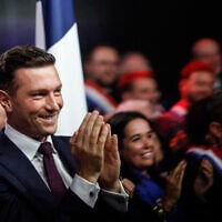 French far-right politician Jordan Bardella applauds as National Rally leader Marine Le Pen (not in picture) speaks in Henin-Beaumont, northern France, on September 13, 2026. (AP/Jean-Francois Badias)