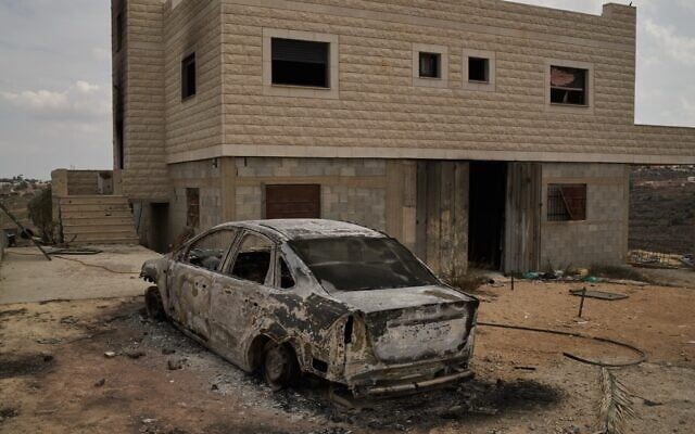 A burnt car is seen in front of one of the two Palestinian houses belonging to the Tubasi family, which were burned by settlers, in the West Bank village of Jalud, September 29, 2026. (AP Photo/Leo Correa)