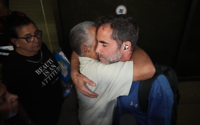 Assaf Rajwan, right, who helped subdue a flydubai copilot who allegedly sought to hijack and crash a plane full of Israelis, at Ben Gurion Airport, September 30, 2026. (AP Photo/Ariel Schalit)