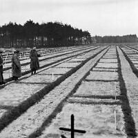 American soldiers of the US 9th army are looking over the vast expanse of grave plots at German Stalag 326-6k in Germany on April 17, 1945, where 30,000 Russian prisoners of war are buried. (Fred Ramage/AP)
