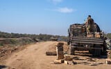 IDF troops are seen outside the Paga military post on the border with the Gaza Strip, December 15, 2023. (Emanuel Fabian/Times of Israel)