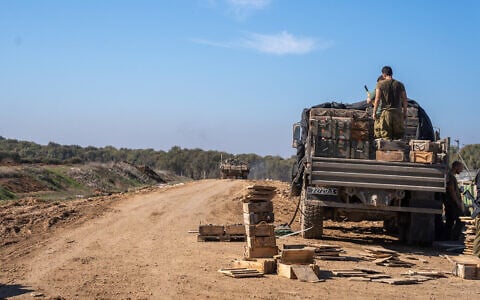 IDF troops are seen outside the Paga military post on the border with the Gaza Strip, December 15, 2023. (Emanuel Fabian/Times of Israel)