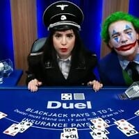 Nelli Levonyan, left, who has appeared multiple times in a full Nazi uniform on Duel.com’s blackjack live streams, sits alongside Paul 'Gypsy Crusader' Miller, who often appears online dressed up as the supervillain the Joker. (Screenshot via JTA)