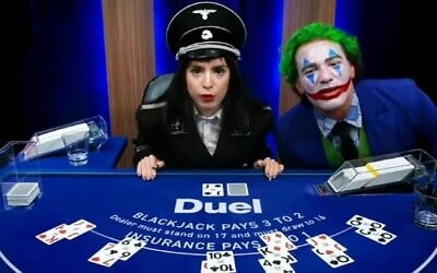 Nelli Levonyan, left, who has appeared multiple times in a full Nazi uniform on Duel.com’s blackjack live streams, sits alongside Paul 'Gypsy Crusader' Miller, who often appears online dressed up as the supervillain the Joker. (Screenshot via JTA)