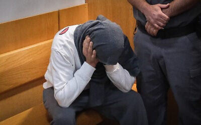 Dennis Mokin, accused of fatally shooting Diar Umari during a road rage clash, is brought for a court hearing at the Nazareth Magistrate’s Court on May 7, 2023. (Fadi Amun/Flash90)