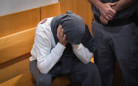 Dennis Mokin, accused of fatally shooting Diar Umari during a road rage clash, is brought for a court hearing at the Nazareth Magistrate’s Court on May 7, 2023. (Fadi Amun/Flash90)