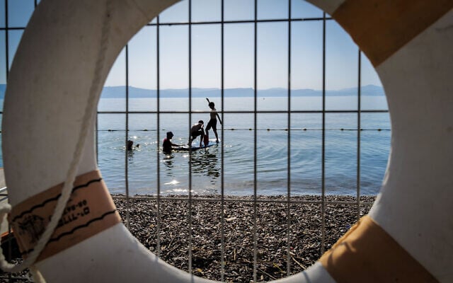 Illustrative: Israeli youngsters at Kursi Beach, Sea of Galilee, on April 17, 2024. (Michael Giladi/Flash90)