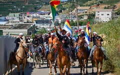 Druze horsemen and cattle growers from the four Golan Heights Druze villages of Majdal Shams, Ein Qiniyye, Buq’ata and Mas’ade parade through the Golan Heights ahead of Eid al-Adha festival, in Majdal Shams, Golan Heights, May 23, 2026. (Michael Giladi/Flash90)