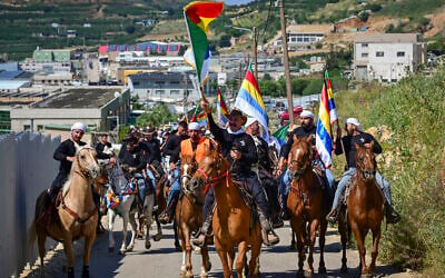 Druze horsemen and cattle growers from the four Golan Heights Druze villages of Majdal Shams, Ein Qiniyye, Buq’ata and Mas’ade parade through the Golan Heights ahead of Eid al-Adha festival, in Majdal Shams, Golan Heights, May 23, 2026. (Michael Giladi/Flash90)