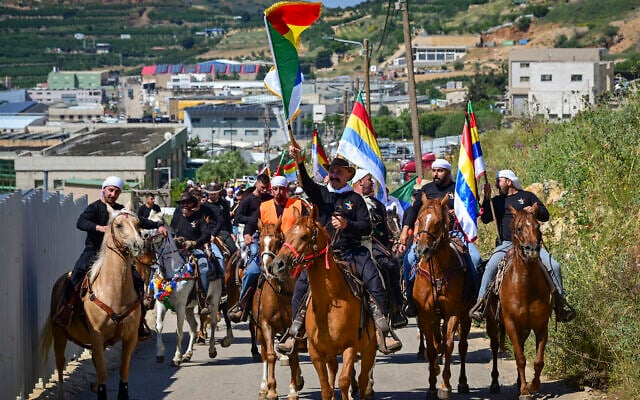 Druze horsemen and cattle growers from the four Golan Heights Druze villages of Majdal Shams, Ein Qiniyye, Buq’ata and Mas’ade parade through the Golan Heights ahead of Eid al-Adha festival, in Majdal Shams, Golan Heights, May 23, 2026. (Michael Giladi/Flash90)