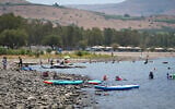 People enjoy the Sea of Galilee in northern Israel on a hot summer day, August 2, 2026. (Michael Giladi/Flash90)
