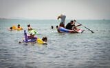 People enjoy the Sea of Galilee (Lake Kinneret) in northern Israel on a hot summer day, August 2, 2026. (Michael Giladi/Flash90)
