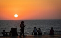Illustrative: People are seen near the beach in Ashkelon on August 10, 2026. (Chaim Goldberg/FLASH90)