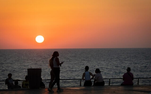 Illustrative: People are seen near the beach in Ashkelon on August 10, 2026. (Chaim Goldberg/FLASH90)
