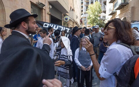 Ultra-Orthodox protesters demonstrate against Cafe Basimta operating on Shabbat and clash with police, while secular protesters hold a counter-demonstration in support of the cafe in central Jerusalem, August 15, 2026. (Oren Ben Hakoon/Flash90)