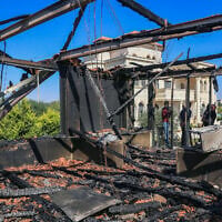 Illustrative: Palestinians inspect a house that was set on fire and spray-painted with graffiti during an attack by a group of extremist Jewish settlers in the village of Osarin, south of Nablus in the West Bank, August 23, 2026. (Nasser Ishtayeh/Flash90)