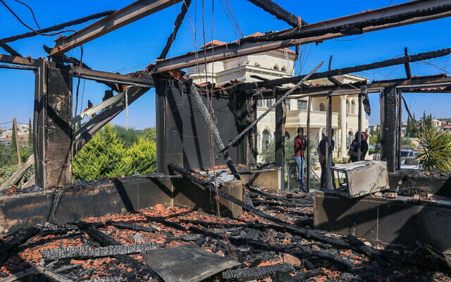 Illustrative: Palestinians inspect a house that was set on fire and spray-painted with graffiti during an attack by a group of extremist Jewish settlers in the village of Osarin, south of Nablus in the West Bank, August 23, 2026. (Nasser Ishtayeh/Flash90)