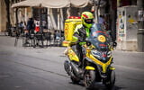 A Magen David Adom paramedic rides an emergency motorcycle on Jaffa Street in central Jerusalem, August 23, 2026. (Nati Shohat/Flash90)