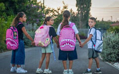 Schoolchildren pose for a picture ahead of the start of the academic year in Moshav Yashresh, August 27, 2026. (Yossi Aloni/Flash90)