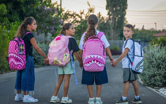 Schoolchildren pose for a picture ahead of the start of the academic year in Moshav Yashresh, August 27, 2026. (Yossi Aloni/Flash90)