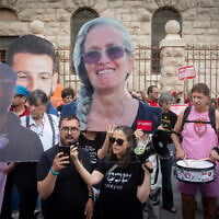 Israeli protesters hold large photographs of Israeli hostages who were killed in Hamas captivity, as they demonstrate on August 31, 2026, outside the Prime Minister's Residence in Jerusalem calling for a state commission of inquiry into failures surrounding the October 7, 2023, Hamas attack. (Chaim Goldberg/FLASH90)