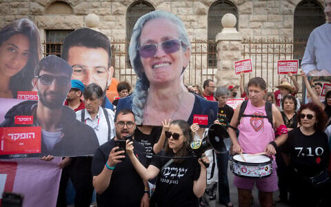 Israeli protesters hold large photographs of Israeli hostages who were killed in Hamas captivity, as they demonstrate on August 31, 2026, outside the Prime Minister's Residence in Jerusalem calling for a state commission of inquiry into failures surrounding the October 7, 2023, Hamas attack. (Chaim Goldberg/FLASH90)