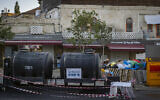 Emergency drinking water tanks are placed near the Old City of Jerusalem amid nationwide water supply disruptions, September 1, 2026. (Chaim Goldberg/Flash90)