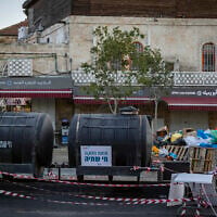 Emergency drinking water tanks are placed near the Old City of Jerusalem amid nationwide water supply disruptions, September 1, 2026. (Chaim Goldberg/Flash90)