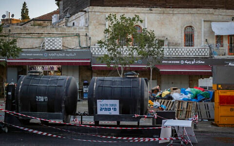 Emergency drinking water tanks are placed near the Old City of Jerusalem amid nationwide water supply disruptions, September 1, 2026. (Chaim Goldberg/Flash90)