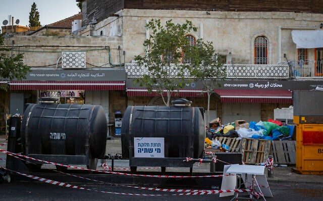 Emergency drinking water tanks are placed near the Old City of Jerusalem amid nationwide water supply disruptions, September 1, 2026. (Chaim Goldberg/Flash90)