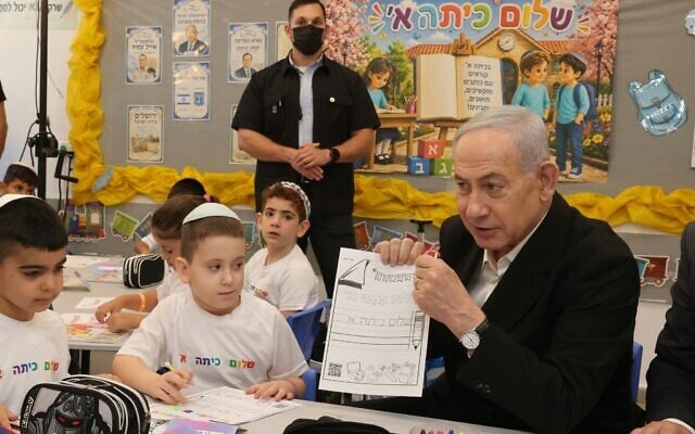 Prime Minister Benjamin Netanyahu visits children on the first day of the new school year in Ramla, central Israel, on September 1, 2026. (Marc Israel Sellem/POOL)