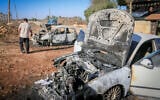 Palestinians inspect burned-out cars after an attack by settlers, where they also spray-painted Hebrew graffiti on the walls of a house in Beita, south of Nablus in the West Bank, September 2, 2026. (Nasser Ishtayeh/Flash90)