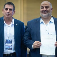 Ra’am party chairman Mansour Abbas (left), together with party member Yoav Segalovitz, arrives to submit the party list to the Central Elections Committee ahead of the upcoming Israeli election at the Knesset, in Jerusalem, September 7, 2026. (Yonatan Sindel/Flash90)
